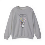 Gray sweatshirt with floral and anatomical heart design on a white background